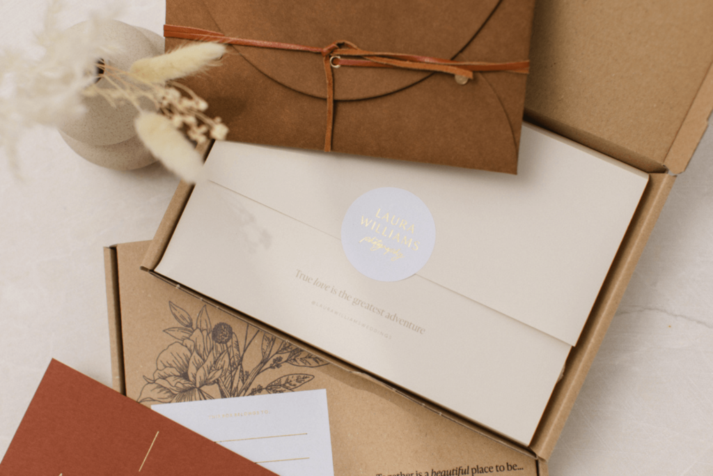 A Kraft shipping box filled with a notecard and a print pouch for a final delivery packaging as a photographer