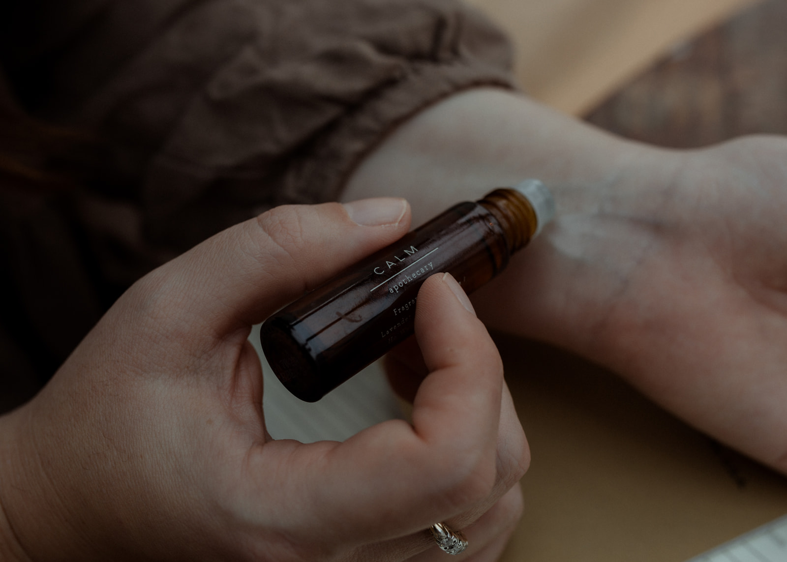 Pulse oil being applied to a wrist to symbolise restoring your balance in business